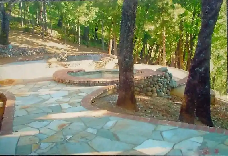 Flagstone-pattern concrete patio with a curved border