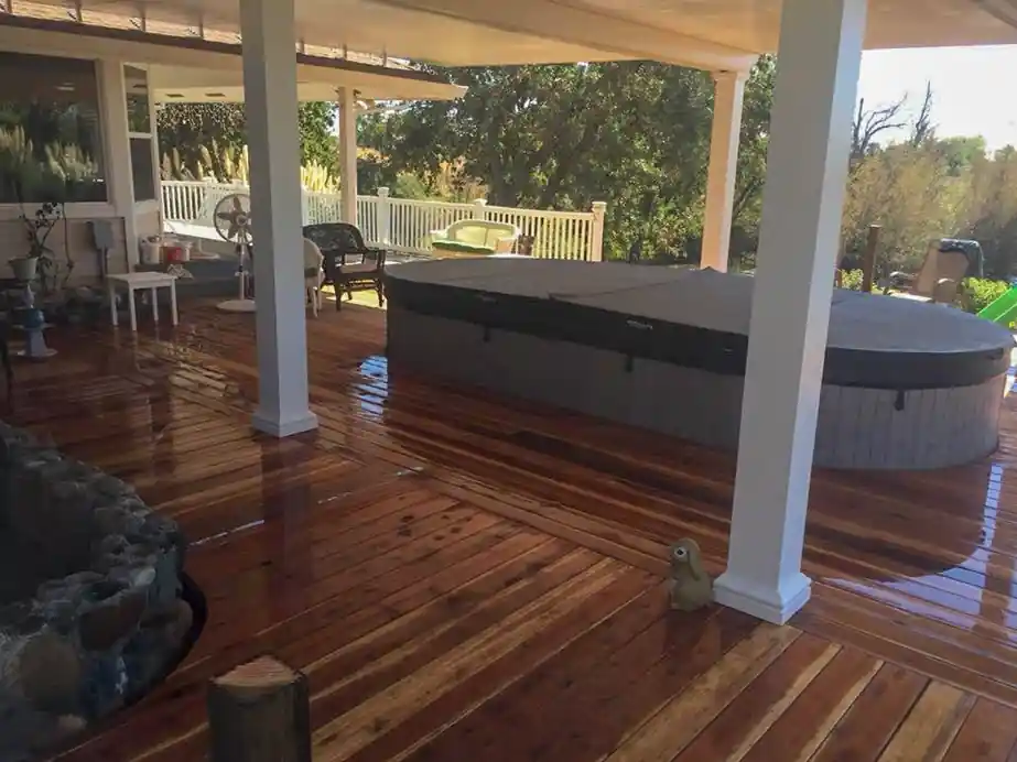 Covered spa on a wooden deck with rails