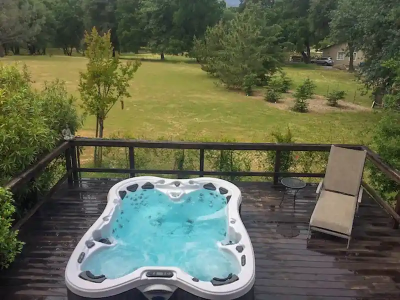 Railed deck built around a hot tub