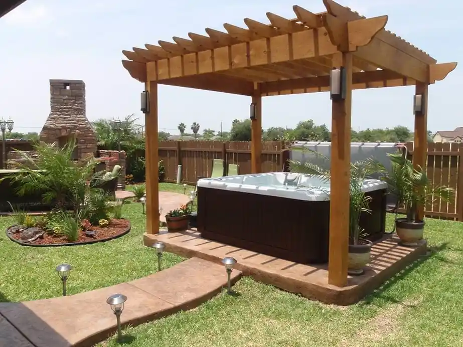 Hot tub under a timber gazebo beside a lawn